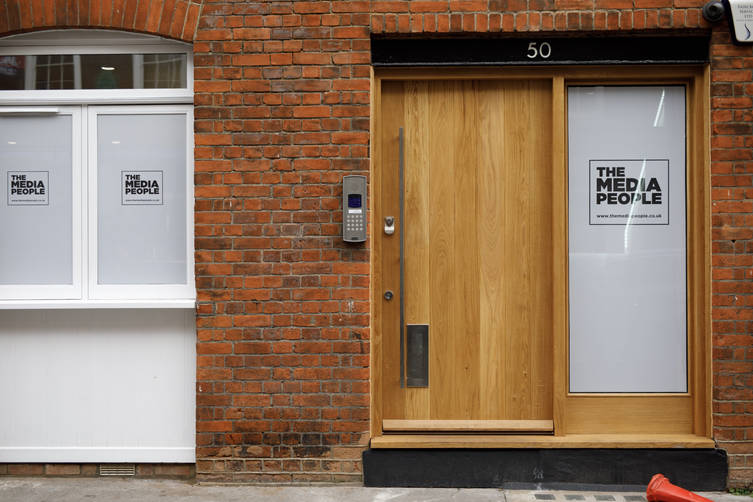 The Media People's office entrance at number 50, with the logo on the windows and glass door panel