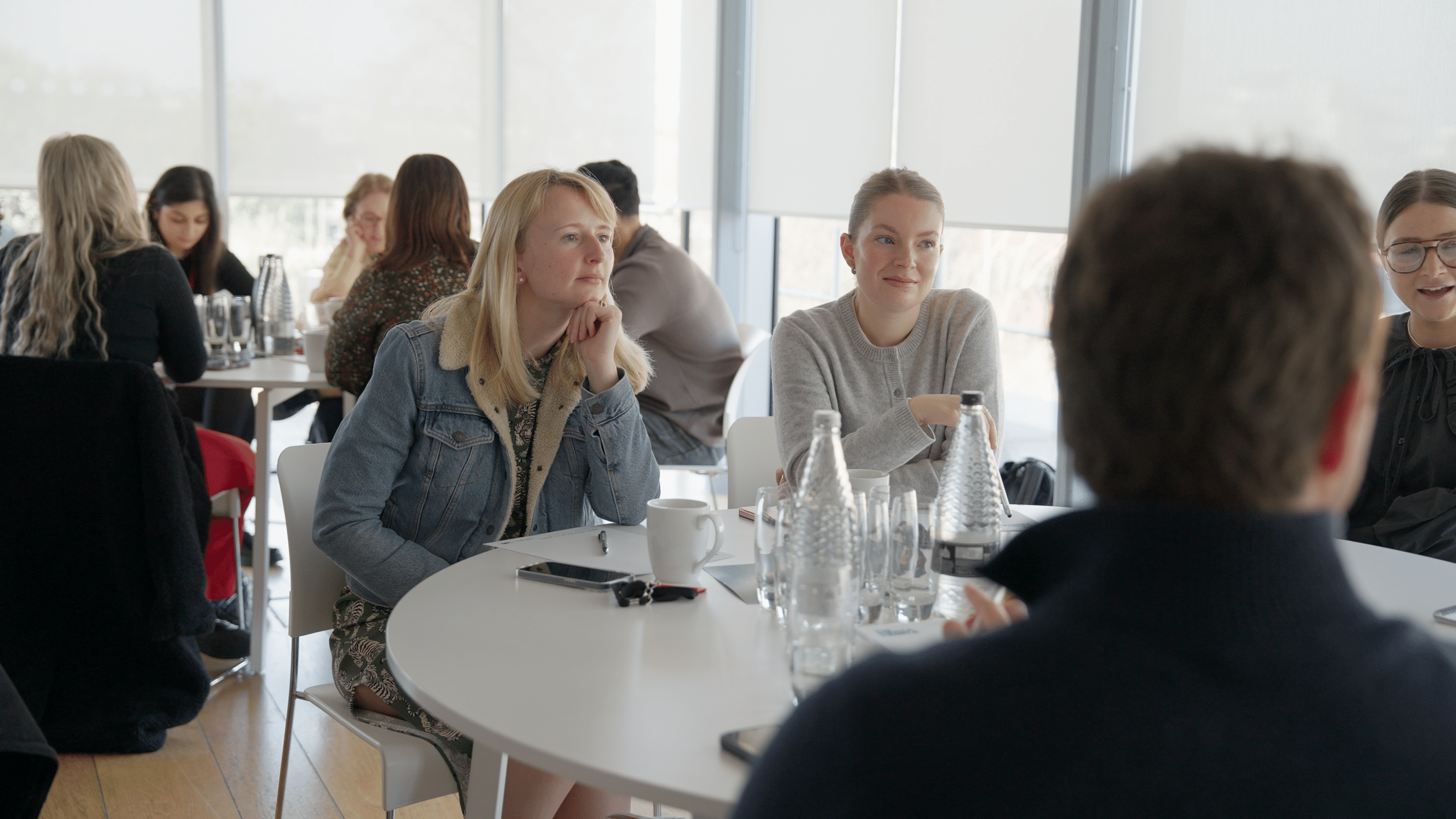 Attendees at a round table listen intently during The Media People's AI Summit