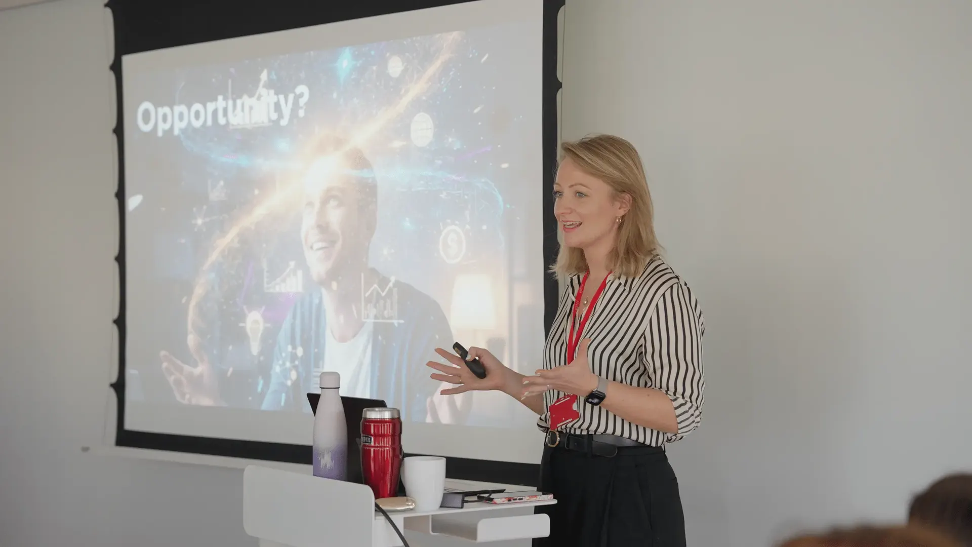 A presenter in a striped shirt speaks in front of a slide headed 'Opportunity?' at The Media People's AI Summit